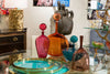 Bottles, Buddha, and Brass